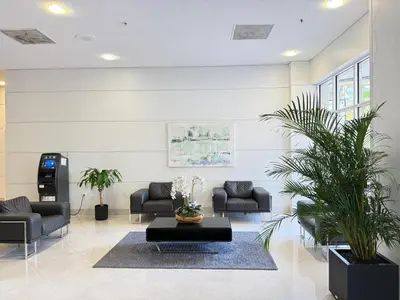 a lobby with couches and a table and plants at 1 SPRING PROMO - Sunny Isles Seaview Condo, Walk to Beach, Amazing Amenities in Sunny Isles Beach