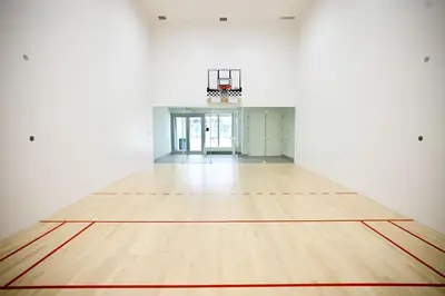 an empty gymnasium with a basketball hoop on a wooden floor at Corner Modern Ocean View Low Floor in Hollywood