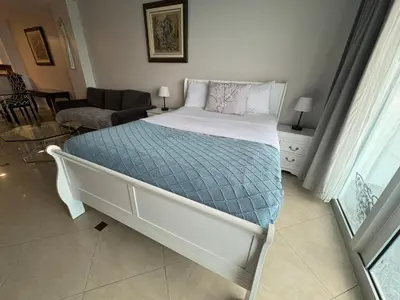 a bedroom with a bed and a living room at Spacious Apt Ocean Reserve Resort Amenities in Sunny Isles Beach