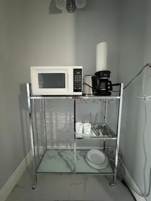 a microwave oven sitting on top of a shelf at Spacious Apt Ocean Reserve Resort Amenities in Sunny Isles Beach
