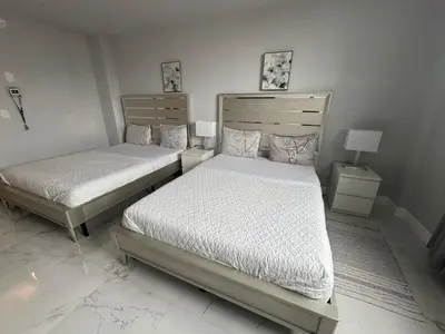 a bedroom with two beds and two night stands at Spacious Apt Ocean Reserve Resort Amenities in Sunny Isles Beach