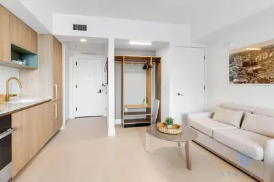 a living room with a couch and a table at Stylish Studio -Amenities & Pool in Miami