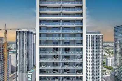 a tall white building in a city with tall buildings at Lovely Studio - Pool & Gym in Miami