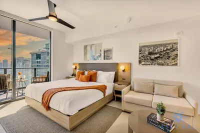 a bedroom with a bed and a couch at Lovely Studio - Pool & Gym in Miami