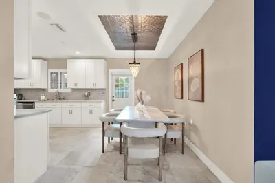 a kitchen with a table and chairs in a room at HUGE Outdoor soccer 4BR HEATED Pool house near Las Olas in Fort Lauderdale