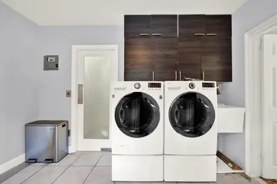 a kitchen with two washing machines in a room at HUGE Outdoor soccer 4BR HEATED Pool house near Las Olas in Fort Lauderdale