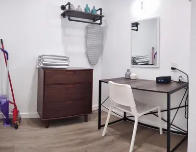 a desk with a chair and a dresser in a room at Charming DBL W pool and parking 15 min to FLL and Beach in Hollywood