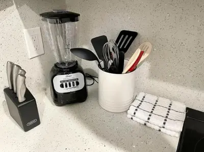 a cup of utensils on a counter next to a blender at Modern in heart of Hollywood in Hollywood
