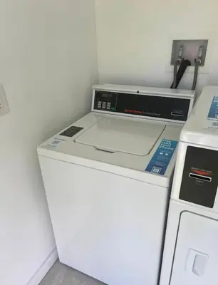 a washer and dryer in a kitchen with a refrigerator at Modern in heart of Hollywood in Hollywood