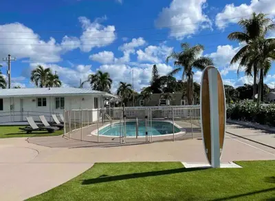 a pool with a surfboard next to a house at Modern in heart of Hollywood in Hollywood