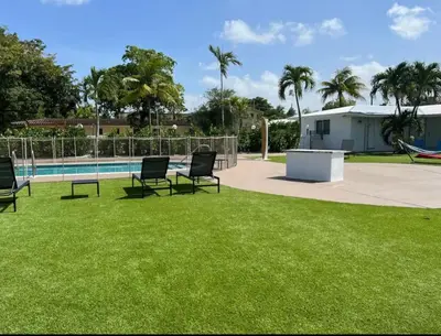 a yard with chairs and a swimming pool at Modern in heart of Hollywood in Hollywood