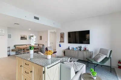a living room with a kitchen and a living room with a table at Grand Vista 4501 in Miami