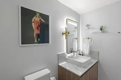 a bathroom with a sink and a picture of a woman at Grand Vista 4501 in Miami