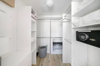 a walk in closet with white cabinets and a microwave at Incredible Ocean View 1BR 1BA Icon Brickell in Miami
