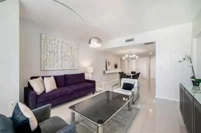 a living room with a purple couch and chairs at Incredible Ocean View 1BR 1BA Icon Brickell in Miami