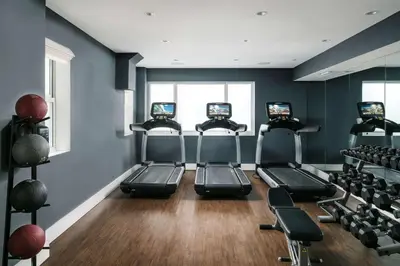a gym with four exercise bikes in a room at Nautilus Sonesta Miami Beach in Miami Beach