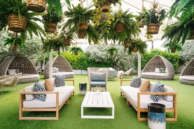 a patio with chairs and tables and plants at Nautilus Sonesta Miami Beach in Miami Beach