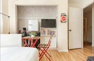 a room with a desk and a table and a kitchen at Beautiful suite in the best location in Miami! in Miami
