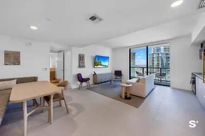 a living room with a couch and a table at Contemporary 2-BD Condo in Downtown Miami - Skyline & Ocean Views in Miami