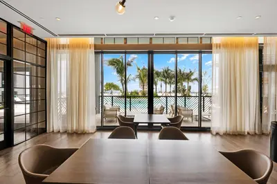 a dining room with a table and a view of the ocean at Contemporary 2-BD Condo in Downtown Miami - Skyline & Ocean Views in Miami