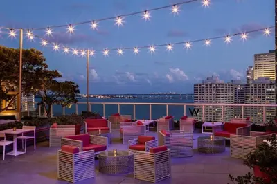 a patio with chairs and tables and lights at Charming Ocean View 2BR 1BA ICON Brickell in Miami