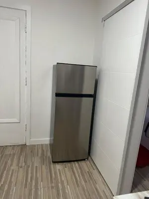 a refrigerator in the corner of a room at Villa Clara Red-Little Havana in Miami
