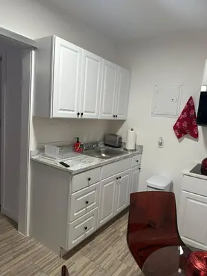 a kitchen with white cabinets and a sink at Villa Clara Red-Little Havana in Miami