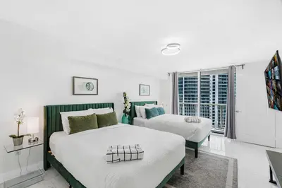 a bedroom with two beds and a window at Exclusivity & Relaxation Offered By Our Condo in Miami