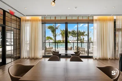 a conference room with a table and chairs and a view of the ocean at Downtown 1-BD Condo with City Views in Miami