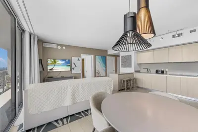 a living room with a table and a kitchen at Stunning High-Floor City View 1BR Hyde Beach House in Hollywood