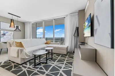 a living room with a couch and a table at Stunning High-Floor City View 1BR Hyde Beach House in Hollywood