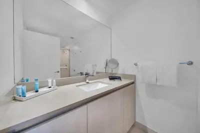 a white bathroom with a sink and a mirror at Beautiful Hyde Resort Luxe 2BR Private Beachfront in Hollywood