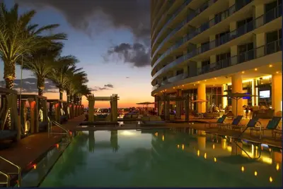 a hotel with a swimming pool in front of a building at Beautiful Hyde Resort Luxe 2BR Private Beachfront in Hollywood