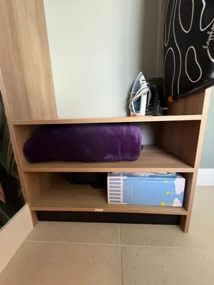 a book shelf with a purple pillow and books at Stunning Lux 2 Bed 2 Bath with Panoramic View from Balcony in Miami