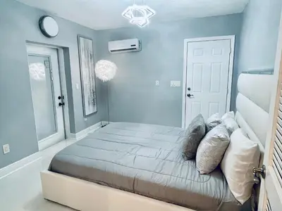 a bedroom with a large bed with blue walls at Best Location!! in Miami