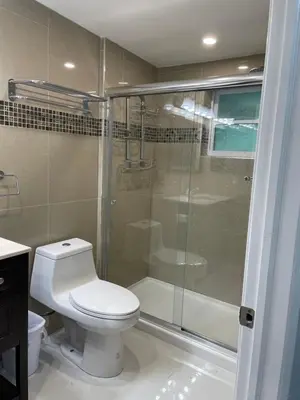 a bathroom with a toilet and a glass shower at Best Location!! in Miami