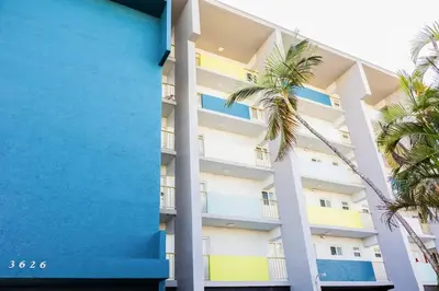 a building with palm trees in front of it at 1BR with Kitchen Eastern Shores near Sunny Isles in North Miami Beach