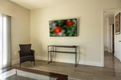 a living room with a table and a chair at 1BR with Kitchen Eastern Shores near Sunny Isles in North Miami Beach
