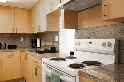 a white stove top oven in a kitchen at 1BR with Kitchen Eastern Shores near Sunny Isles in North Miami Beach