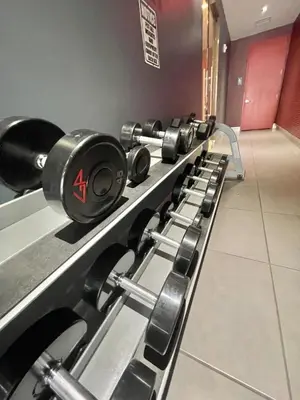 a row of dumbbells lined up in a gym at 1 Bedroom & Kitchen at Beachwalk Luxe Pool - Gym in Hallandale Beach