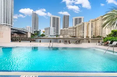a large swimming pool with a city skyline in the background at Amazing Studio at Beachwalk on 15th Pool Gym Beach in Hallandale Beach