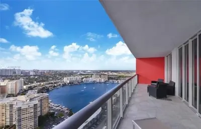 a balcony with a view of a body of water at 2 Bed 2 Bath Penthouse Amazing Views Beach Service in Hallandale Beach