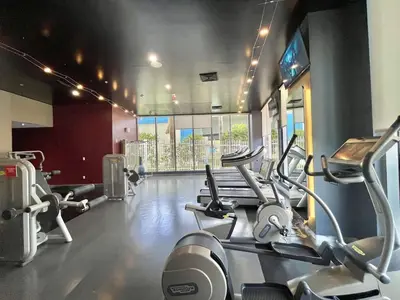 a gym with several cardio machines in a room at 2 Bed 2 Bath Penthouse Amazing Views Beach Service in Hallandale Beach