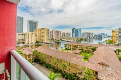 a balcony with a view of a river and buildings at Amazing Studio at Beachwalk with Pool & Gym in Hallandale Beach