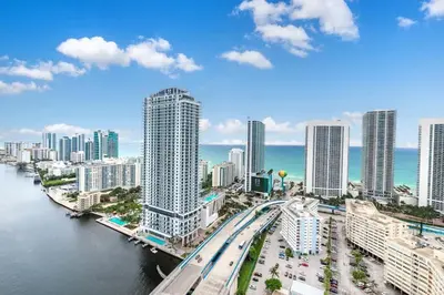 a view of a city with a river and buildings at Amazing Studio at Beachwalk with Pool & Gym in Hallandale Beach