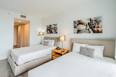 two beds in a room with white walls at 2BR & 2BA Oasis at Beachwalk in Hallandale Beach