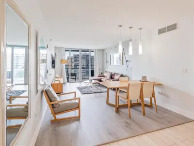 a white living room with a table and chairs at 1 Bedroom w Kitchen on Beachwalk Beach &Pool &Gym in Hallandale Beach