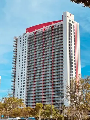 a large tall building with a red and white top at 1 Bedroom w Kitchen on Beachwalk Beach &Pool &Gym in Hallandale Beach