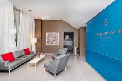 a living room with a couch and two chairs at 1 Bedroom w Kitchen on Beachwalk Beach &Pool &Gym in Hallandale Beach