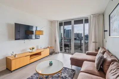 a living room with a couch and a table at 1 Bedroom w Kitchen on Beachwalk Beach &Pool &Gym in Hallandale Beach